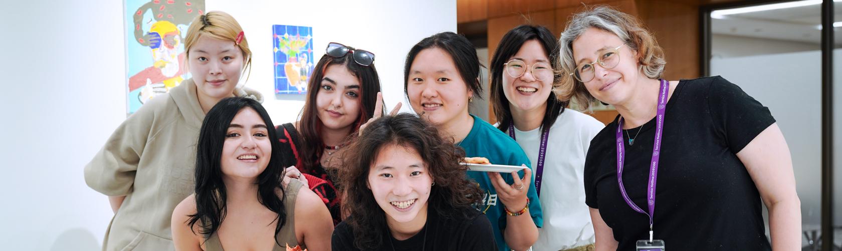 group photo between students and faculty infront of student exhibition