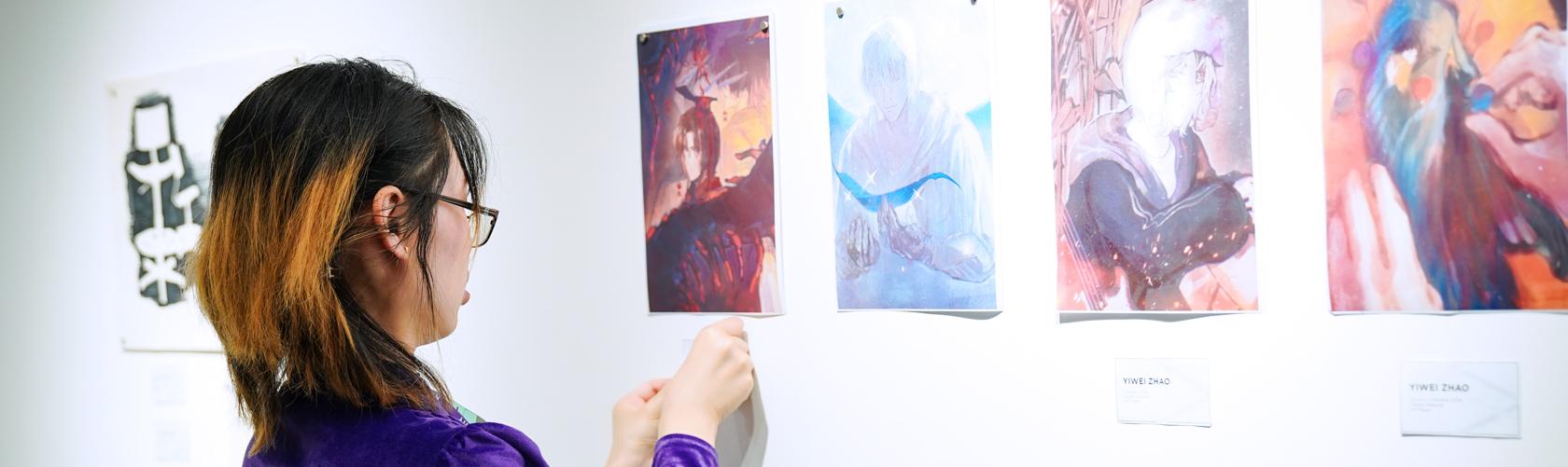 student photographing their artwork